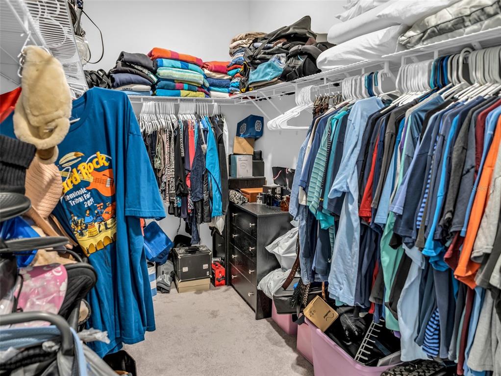 7474 Southwest 78th Terrace Ocala, FL 34481 - Photo 50 of 58 a view of walk in closet with clothes and shoes