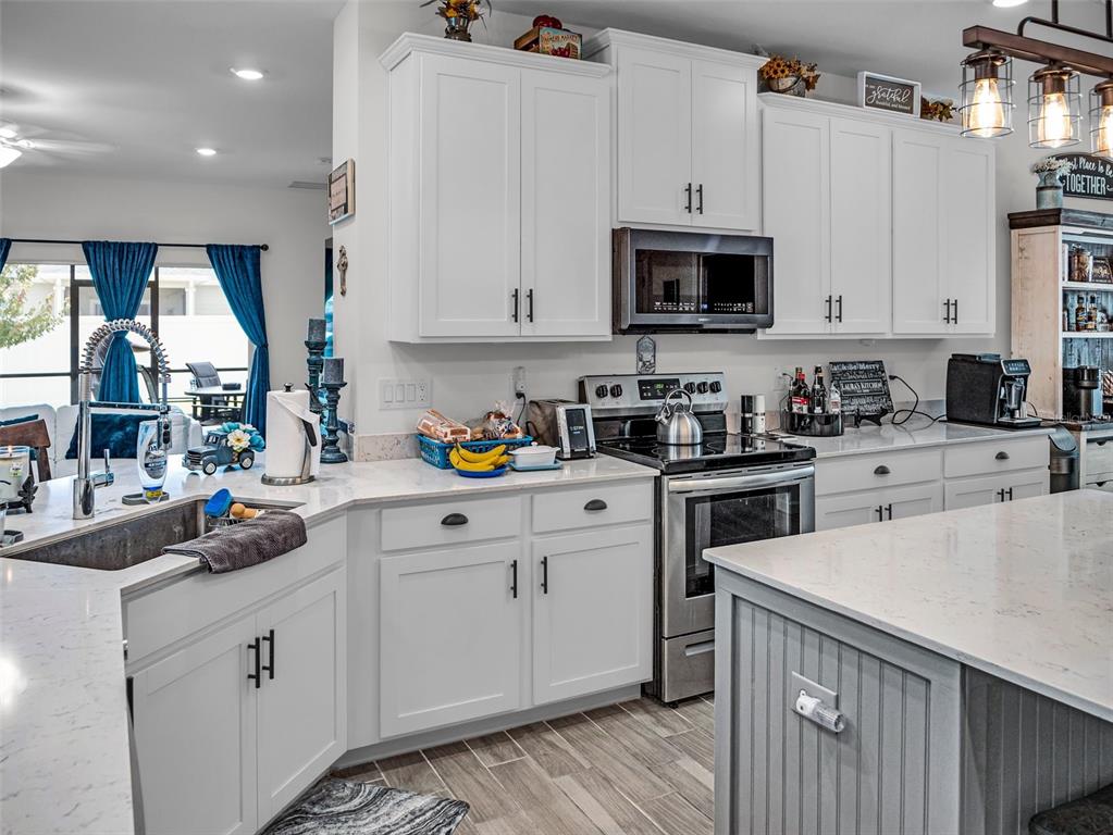 7474 Southwest 78th Terrace Ocala, FL 34481 - Photo 10 of 58 a kitchen with stainless steel appliances white cabinets and a sink