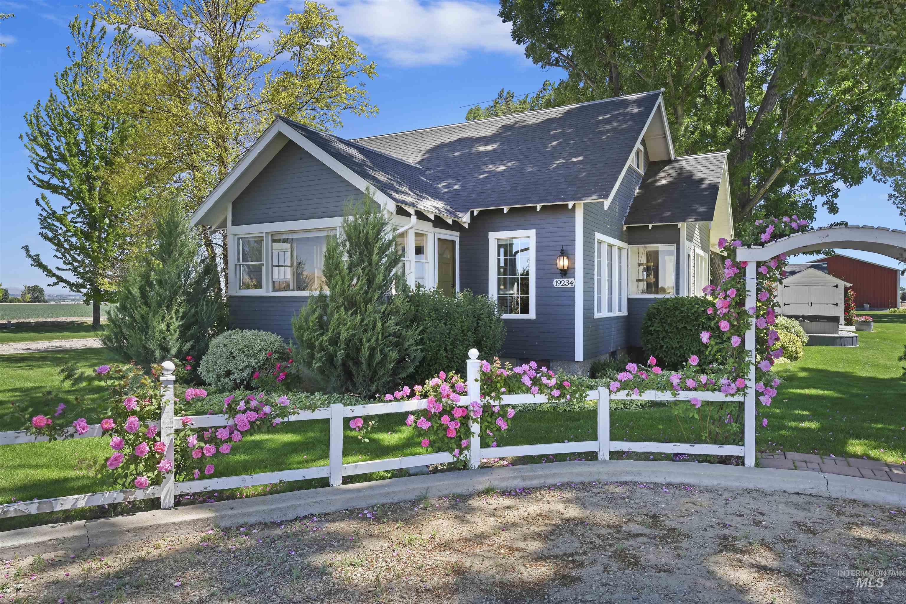 View of front facade featuring a front lawn and roof with shingles