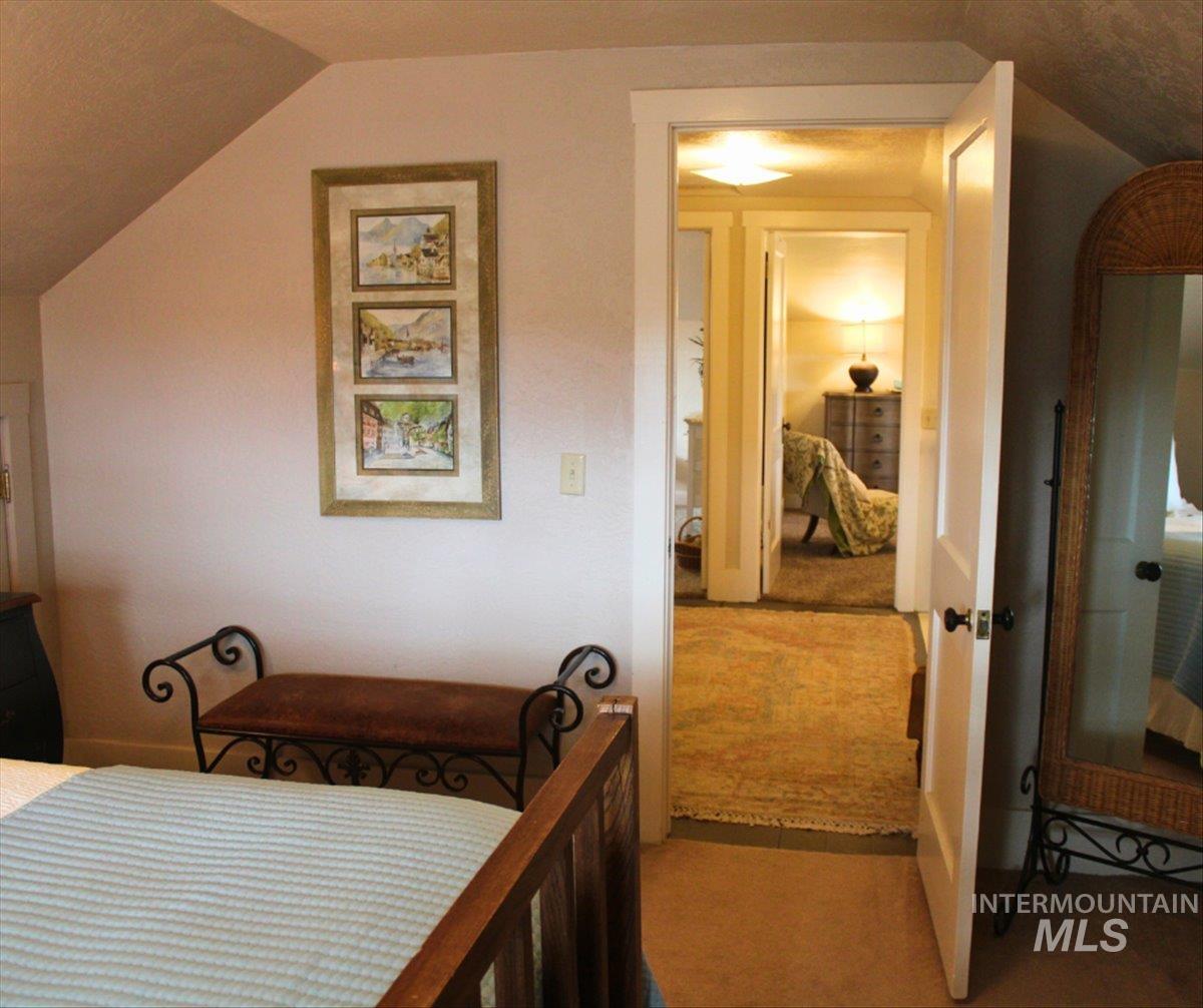 19234 Top Road Caldwell, ID 83607 - Photo 17 of 50 Bedroom featuring light carpet and vaulted ceiling