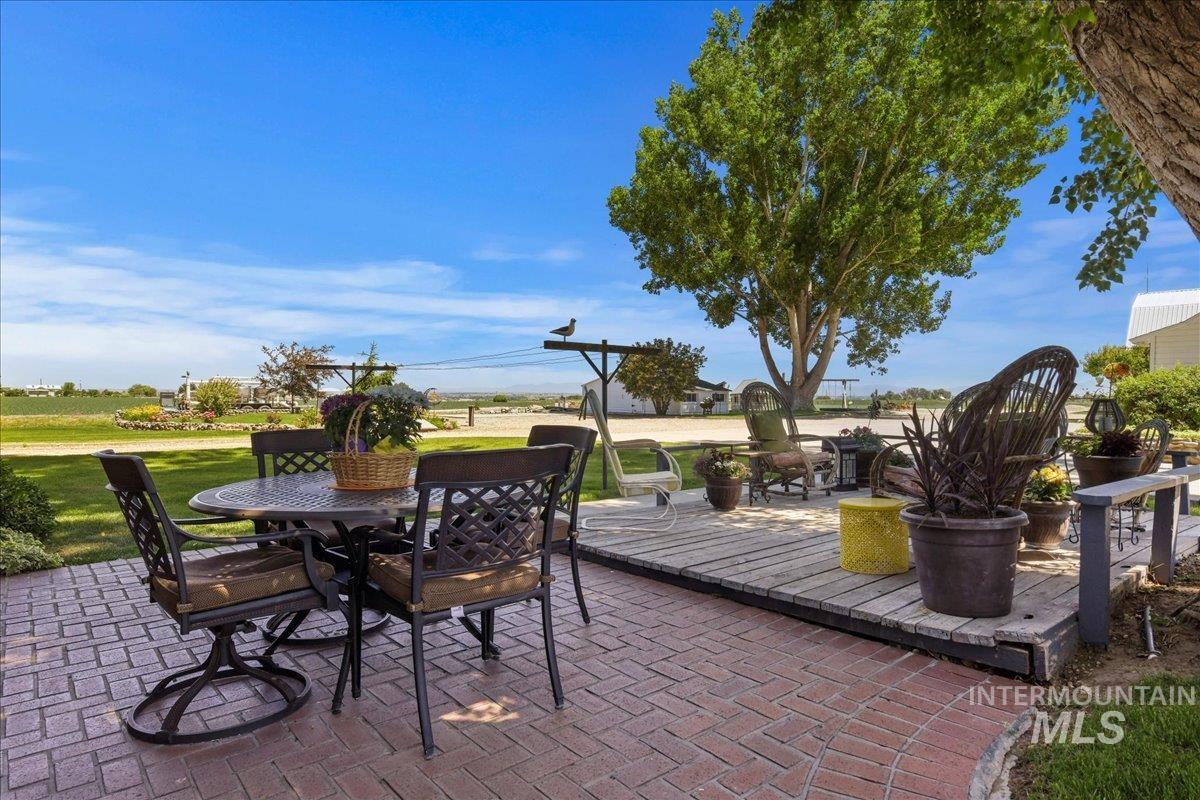 19234 Top Road Caldwell, ID 83607 - Photo 18 of 50 View of patio featuring outdoor dining area and a wooden deck