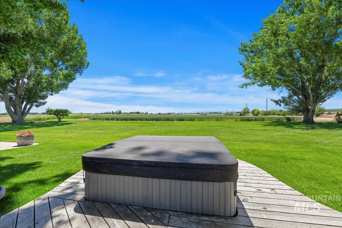 19234 Top Road Caldwell, ID 83607 - Photo 19 of 50 Wooden deck featuring a lawn, a view of rural / pastoral area, and a hot tub