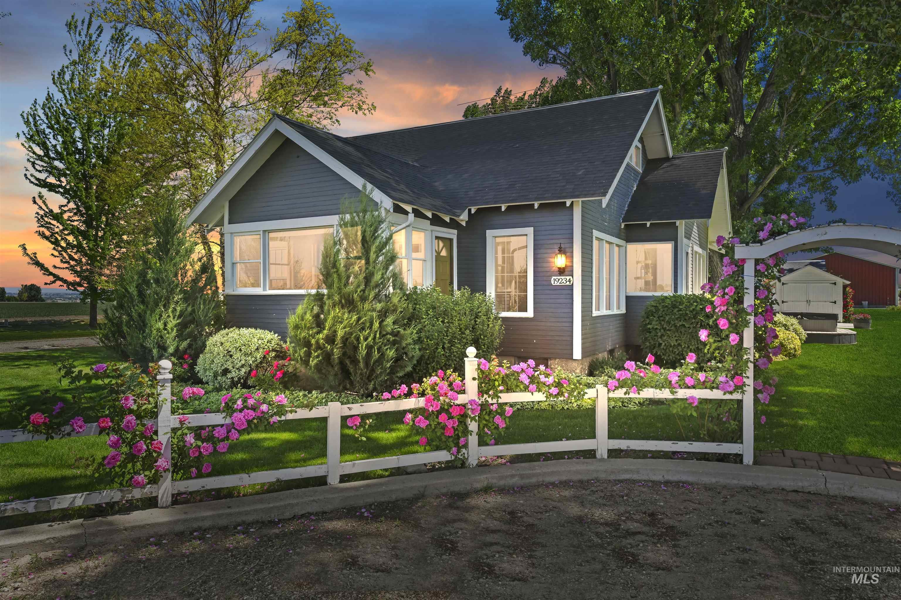 19234 Top Road Caldwell, ID 83607 - Photo 2 of 50 View of front of home featuring a front yard and a shingled roof