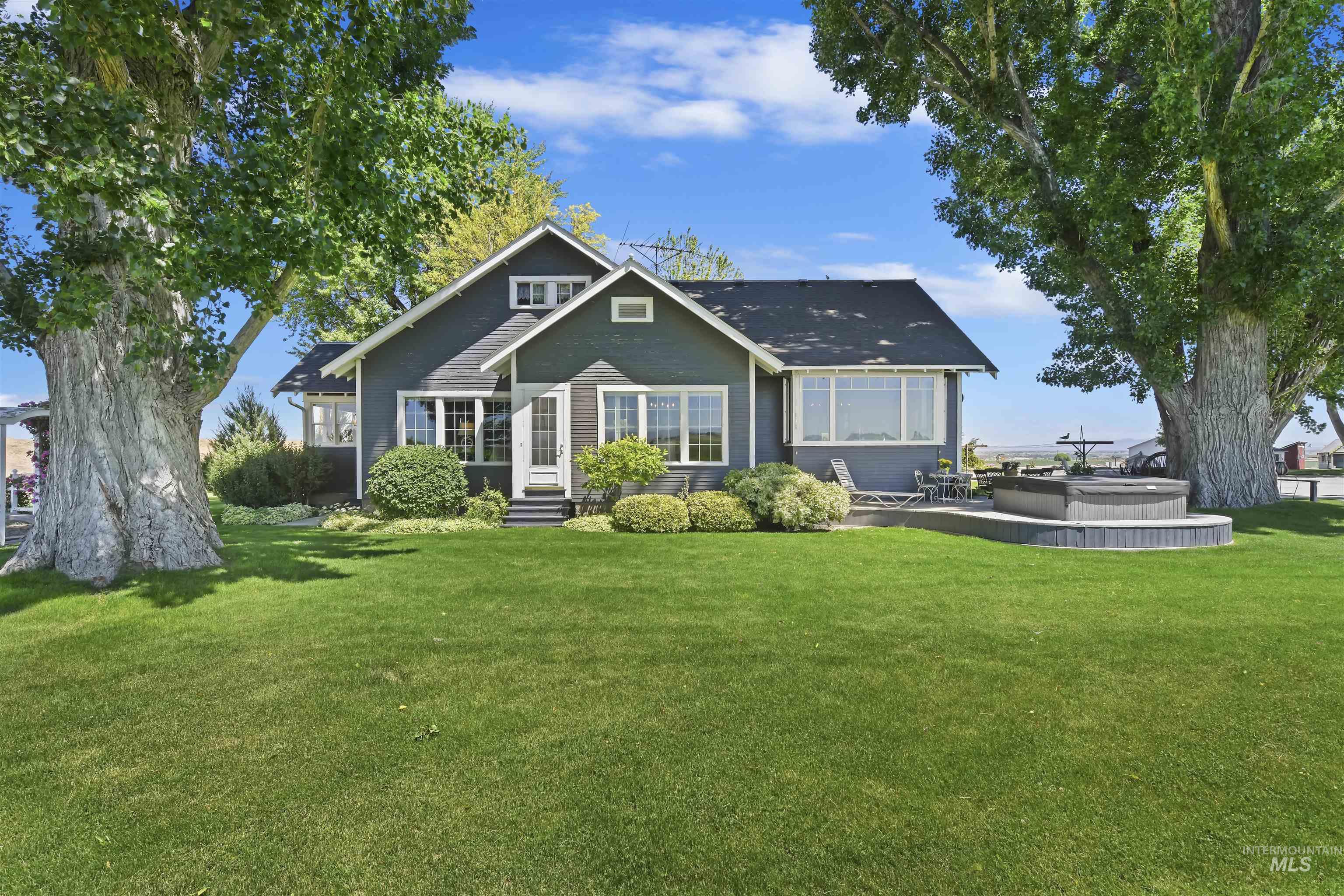 19234 Top Road Caldwell, ID 83607 - Photo 4 of 50 Rear view of house with a yard, a jacuzzi, entry steps, and a patio area