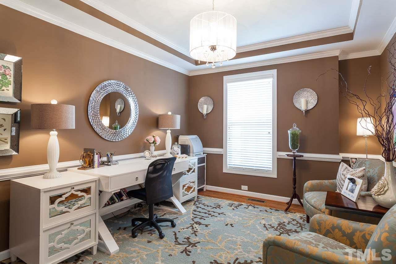 1014 Vino Drive Raleigh, NC 27607 - Photo 19 of 25 a living room with furniture a window and a clock