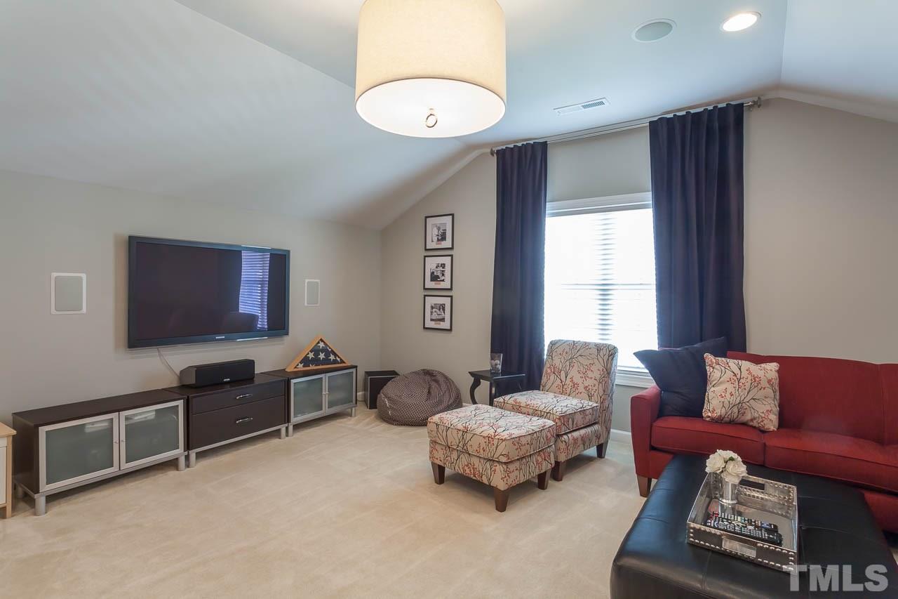 1014 Vino Drive Raleigh, NC 27607 - Photo 24 of 25 a living room with furniture and a flat screen tv