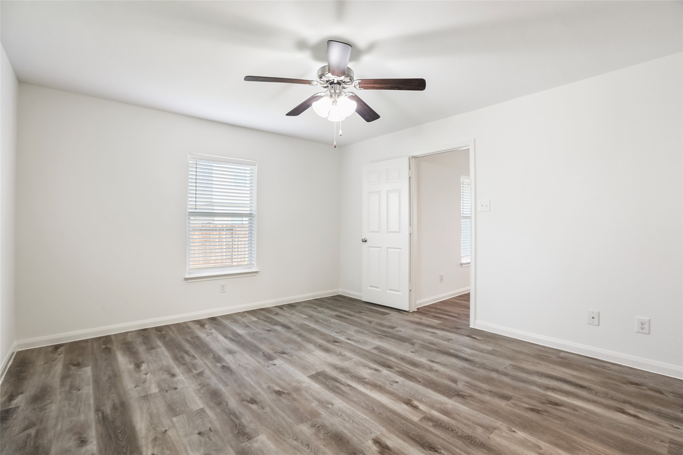 100 Robertson Lane Jarrell, TX 76537 - Photo 11 of 29 Primary bedroom with ceiling fan and views to the backyard