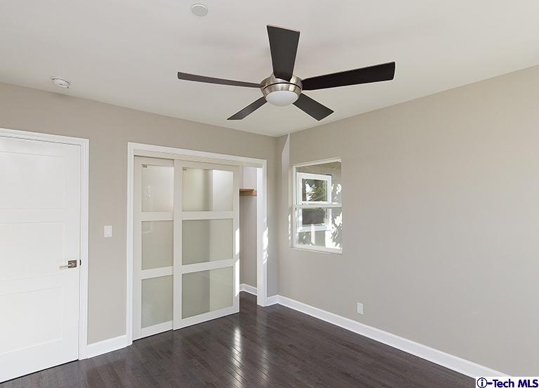 3675 Newhaven Road Pasadena, CA 91107 - Photo 22 of 39 an empty room with wooden floor ceiling fan and windows