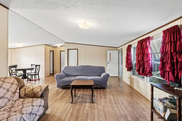 a living room with furniture and a wooden floor