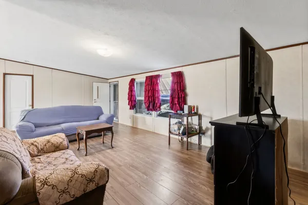 a kitchen with a dining table chairs and refrigerator