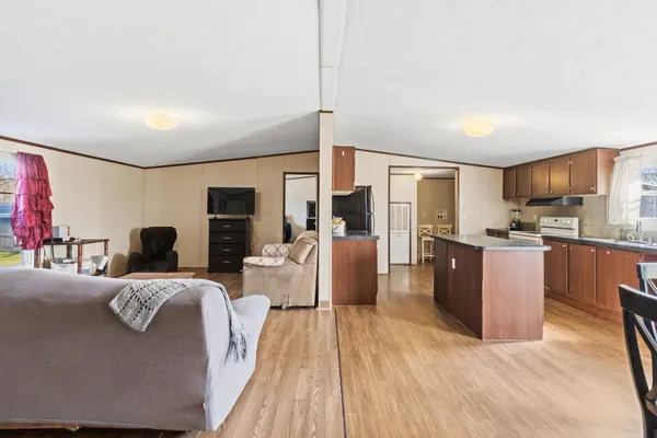 a dining room with furniture and wooden floor