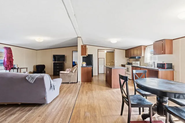 a kitchen with stainless steel appliances granite countertop a sink stove microwave and refrigerator