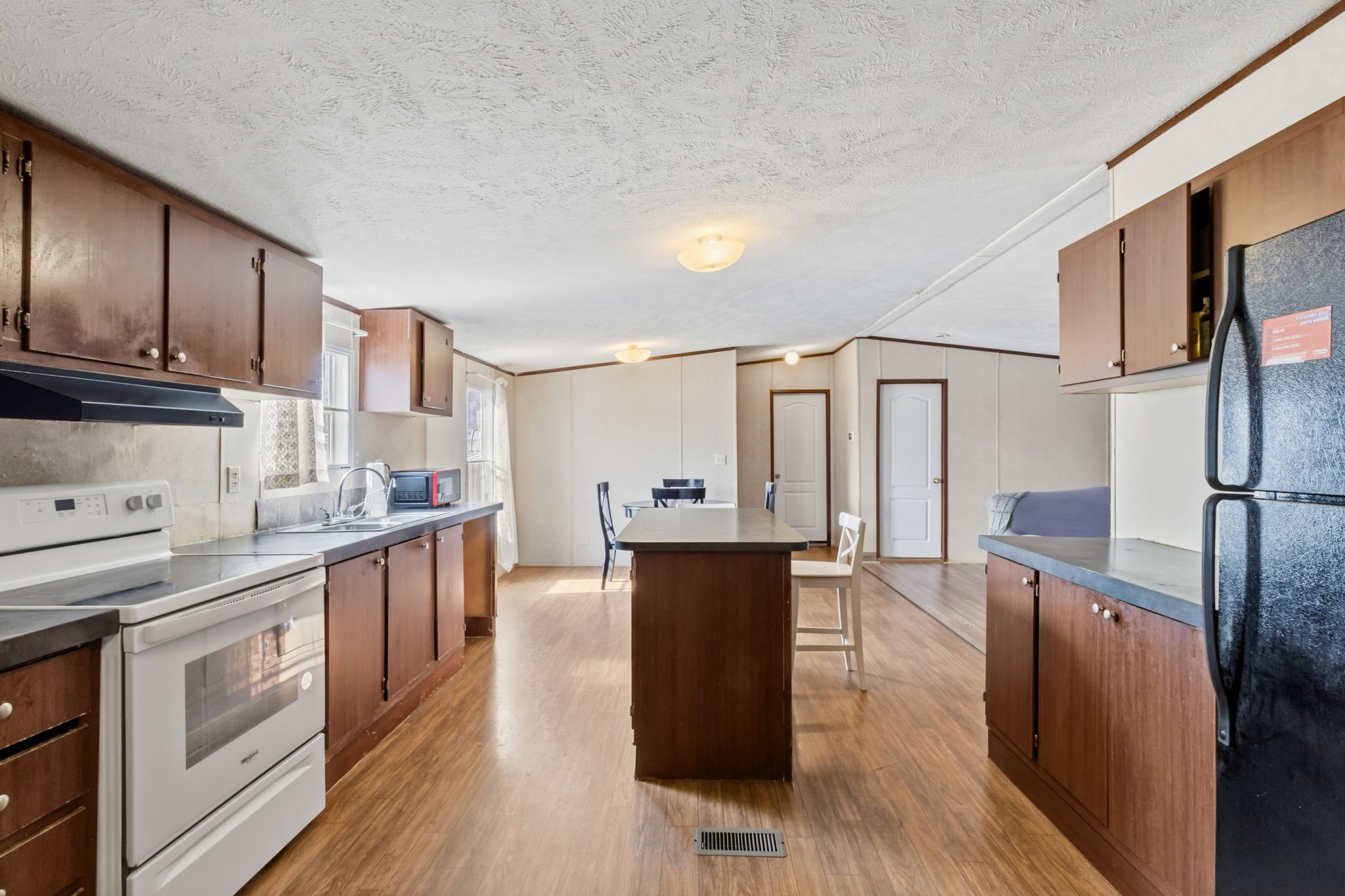 3412 Huffman-Eastgate Road Huffman, TX 77336 - Photo 22 of 43 a kitchen with stainless steel appliances granite countertop a sink dishwasher stove and wooden cabinets with wooden floor