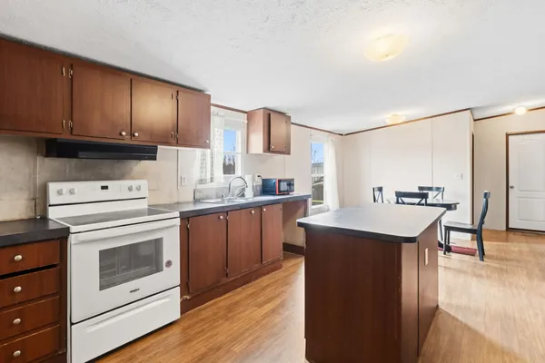 a bedroom with a bed dresser and a window