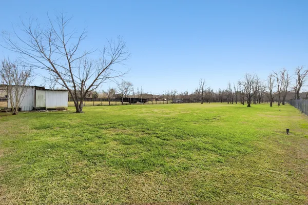 a view of a field with an trees in the background