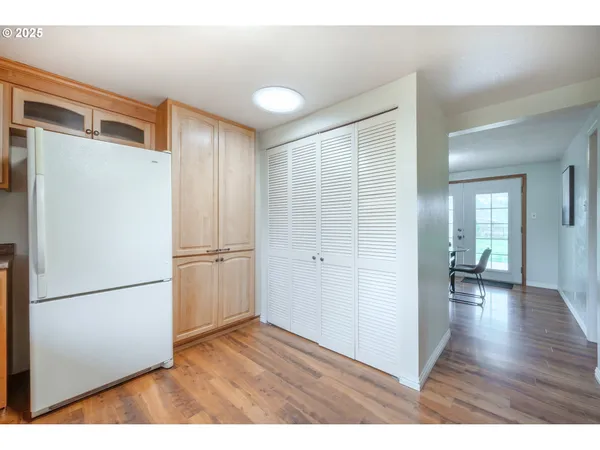 a view of empty room with wooden floor