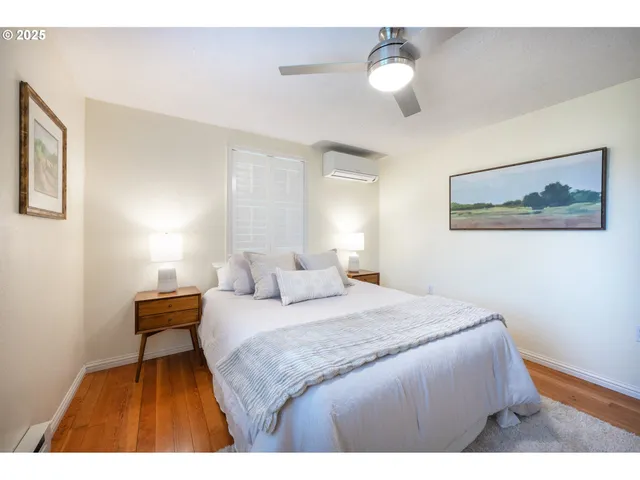 a bedroom with a bed and a painting on the wall