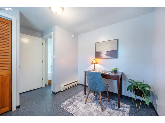 a workspace room with furniture and wooden floor