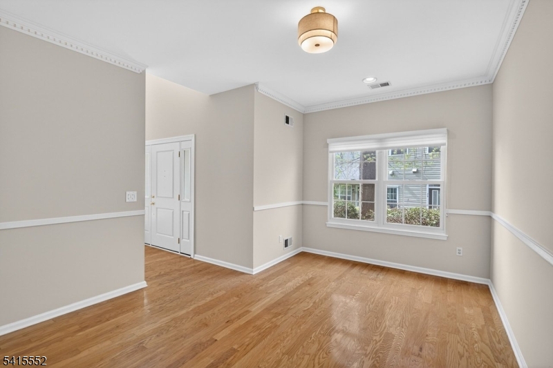 33 Four Oaks Road Bedminster, NJ 07921 - Photo 16 of 29 an empty room with wooden floor and windows