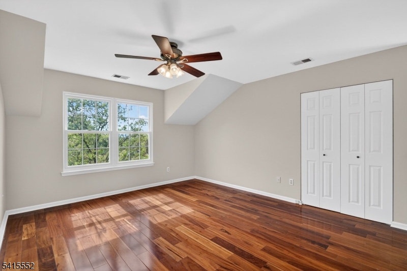 33 Four Oaks Road Bedminster, NJ 07921 - Photo 20 of 29 a view of empty room with wooden floor and fan