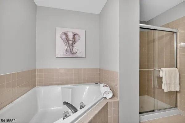 a bathroom with a granite countertop sink a toilet and shower