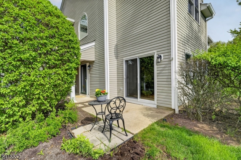 33 Four Oaks Road Bedminster, NJ 07921 - Photo 28 of 29 a view of a chair and table in backyard of the house
