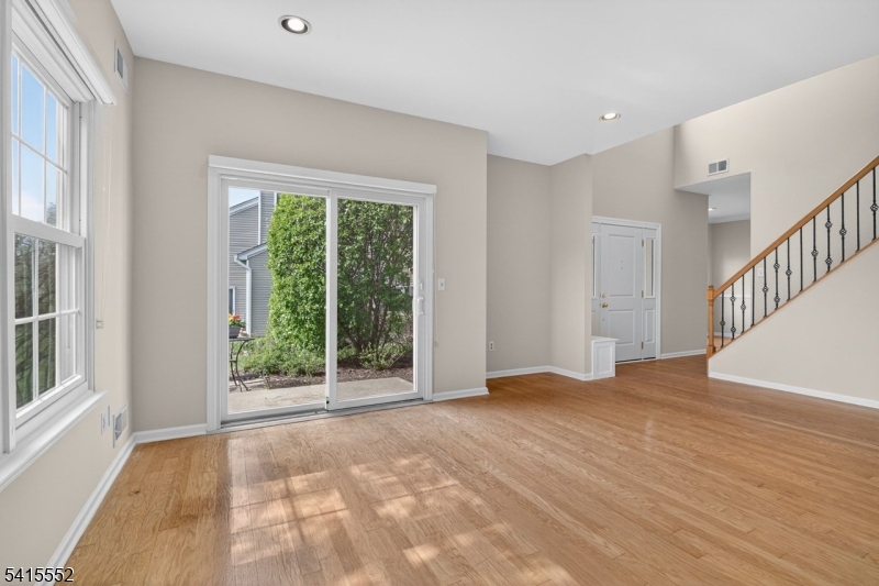 33 Four Oaks Road Bedminster, NJ 07921 - Photo 6 of 29 a view of an empty room with wooden floor and a window