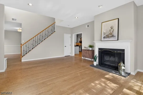 a kitchen with stainless steel appliances granite countertop a table chairs sink and cabinets