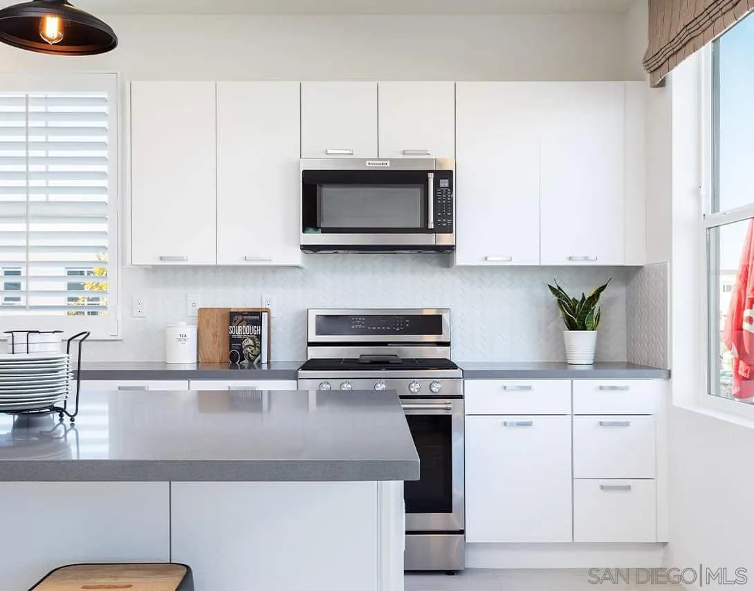 35116 Vine Place Fallbrook, CA 92028 - Photo 3 of 4 a kitchen with stainless steel appliances granite countertop a sink a stove and a microwave