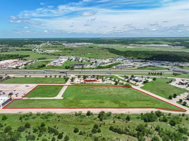 a view of a field with an ocean