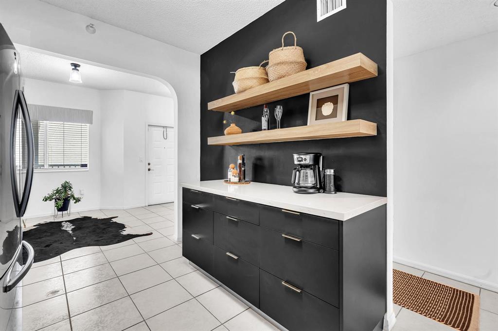 7775 Southampton Terrace, Unit 405 Tamarac, FL 33321 - Photo 11 of 82 a kitchen with stainless steel appliances a sink and cabinets