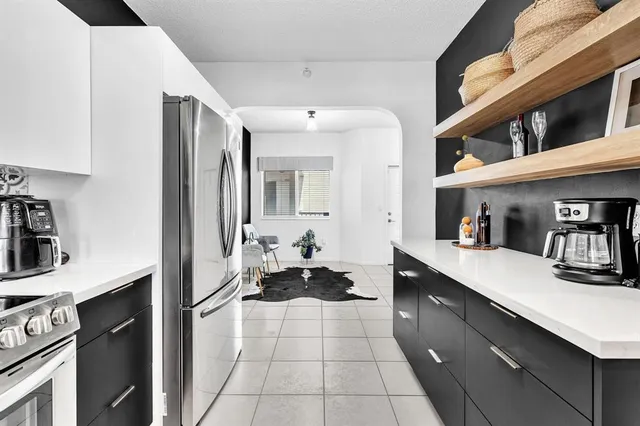 a view of a dining room with furniture a chandelier and wooden floor