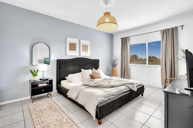 a bedroom with bed and chair