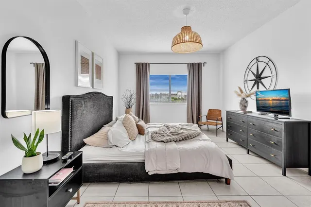 a bedroom with a bed and a chandelier