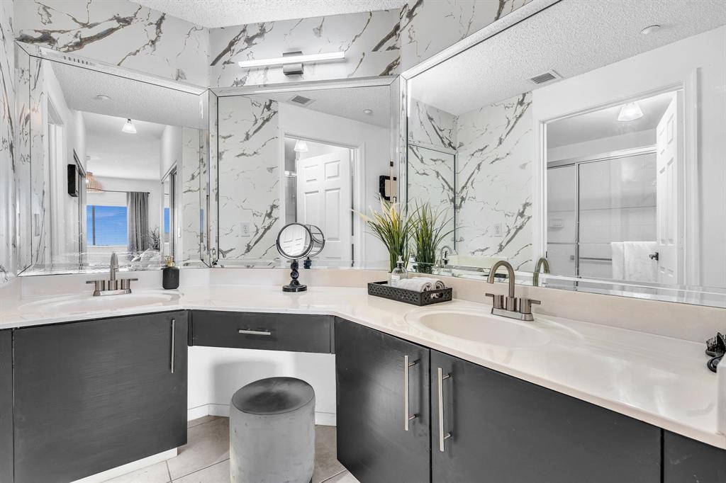 7775 Southampton Terrace, Unit 405 Tamarac, FL 33321 - Photo 32 of 82 a bathroom with a sink double vanity and a mirror