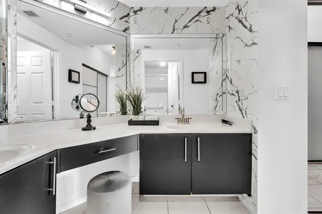 a view of a porch with chairs and potted plants