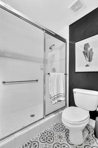 a view of a balcony with chairs and a potted plant