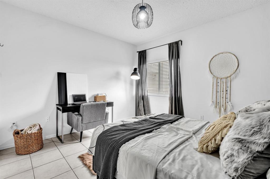 7775 Southampton Terrace, Unit 405 Tamarac, FL 33321 - Photo 38 of 82 a bedroom with bed and chair