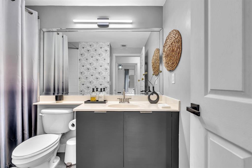 7775 Southampton Terrace, Unit 405 Tamarac, FL 33321 - Photo 40 of 82 a bathroom with a sink a toilet and a mirror