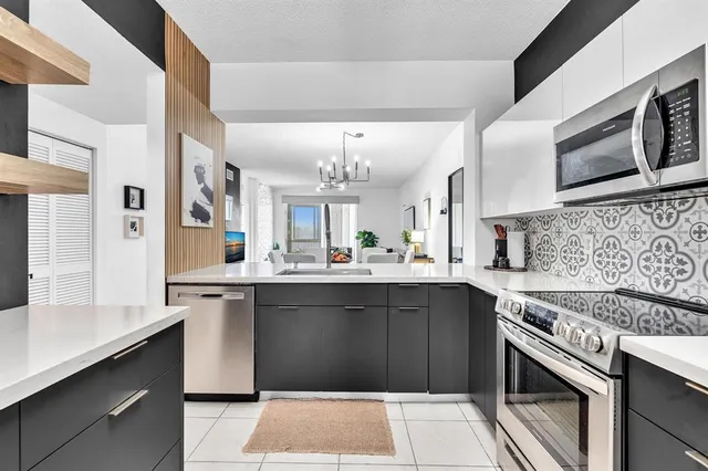 a kitchen with stainless steel appliances granite countertop a refrigerator stove and microwave