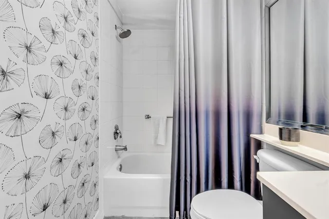 a view of a livingroom with furniture and a large window