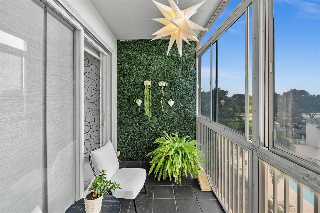7775 Southampton Terrace, Unit 405 Tamarac, FL 33321 - Photo 46 of 82 a view of a porch with chairs and potted plants