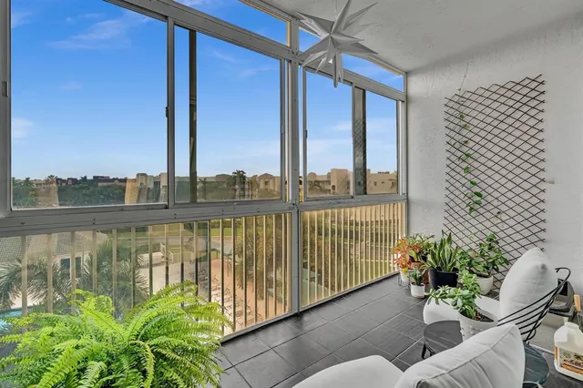 an aerial view of a city with lots of residential buildings and mountain view in back