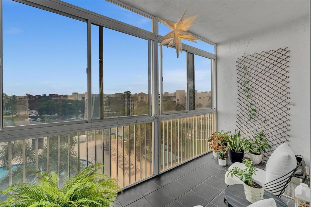 7775 Southampton Terrace, Unit 405 Tamarac, FL 33321 - Photo 50 of 82 a view of a chair and table in the balcony