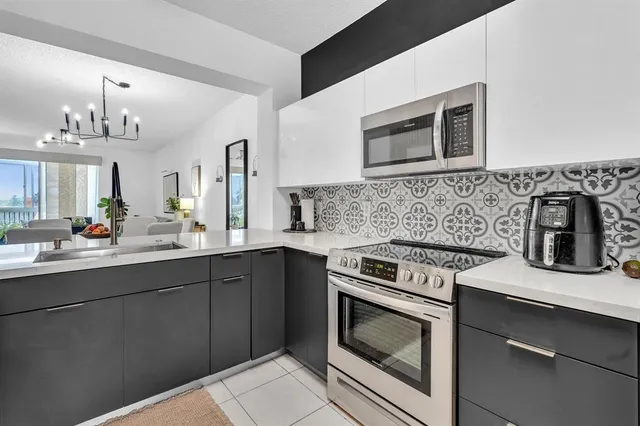 a kitchen with stainless steel appliances a sink and cabinets