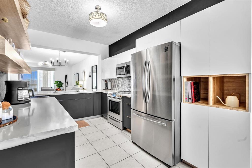7775 Southampton Terrace, Unit 405 Tamarac, FL 33321 - Photo 9 of 82 a kitchen with stainless steel appliances a refrigerator sink and cabinets