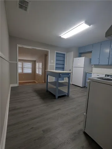 a view of a livingroom with furniture and a kitchen