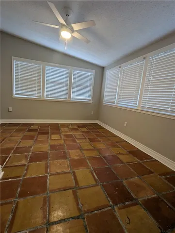 a view of a livingroom with an empty space and a window
