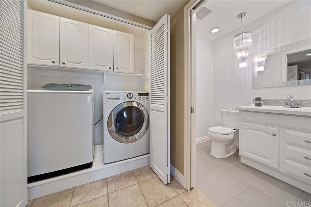 10 Windflower Aliso Viejo, CA 92656 - Photo 12 of 41 Laundry Closet with Built-in Cabinets and Recessed Lighting Next to Main Level Full Bathroom
