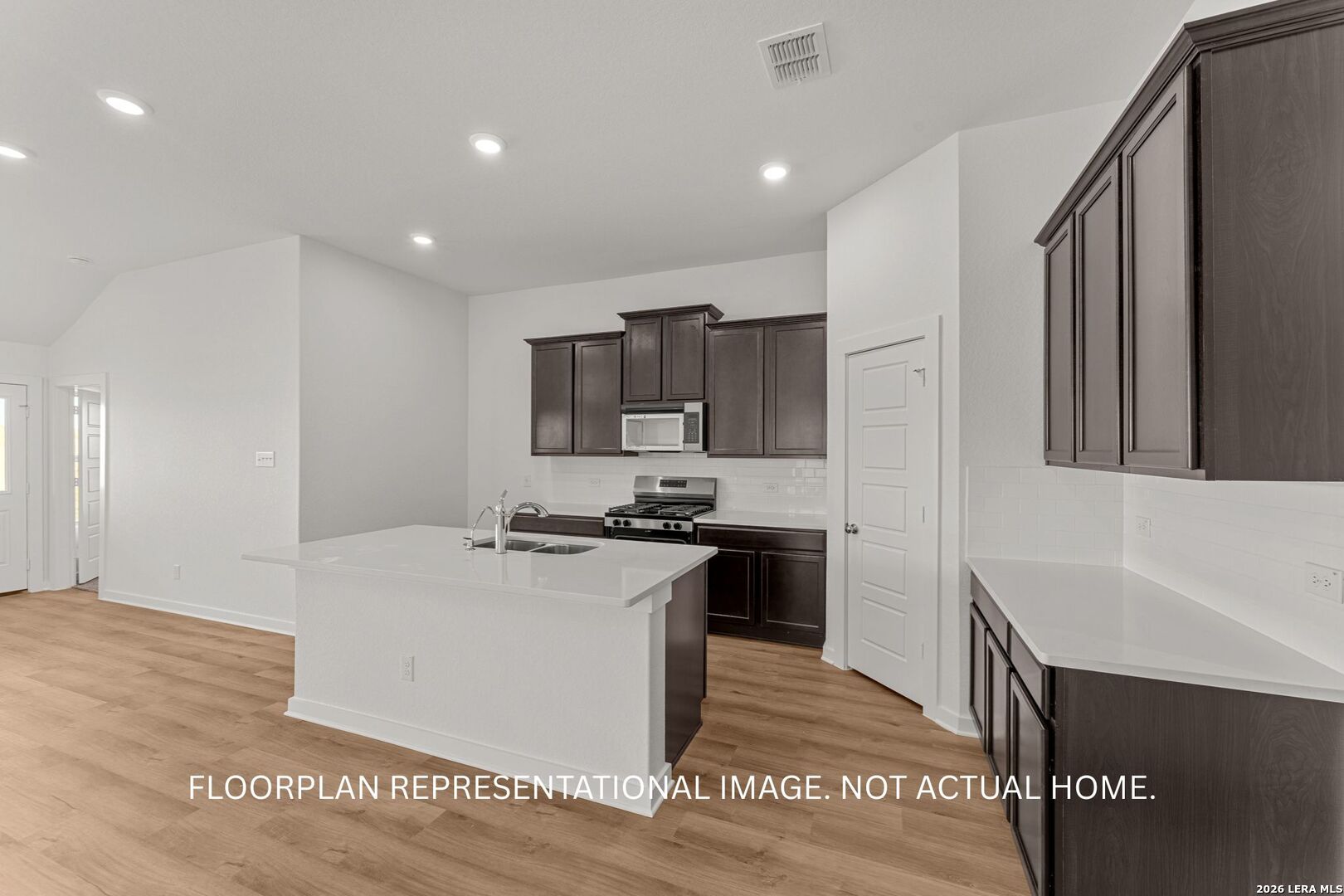 2914 Midlothian Way Converse, TX 78109 - Photo 9 of 16 a kitchen with stainless steel appliances a sink a stove a refrigerator and cabinets